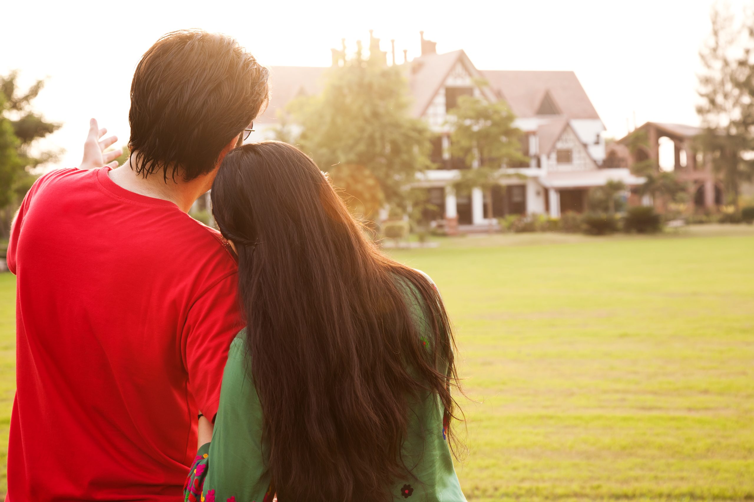 Couple,Standing,With,Their,Backs,Towards,Camera,,Couple,Standing,Against